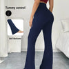 A model wearing navy blue high-waisted yoga leggings with flare details, demonstrating tummy control and bell bottoms.