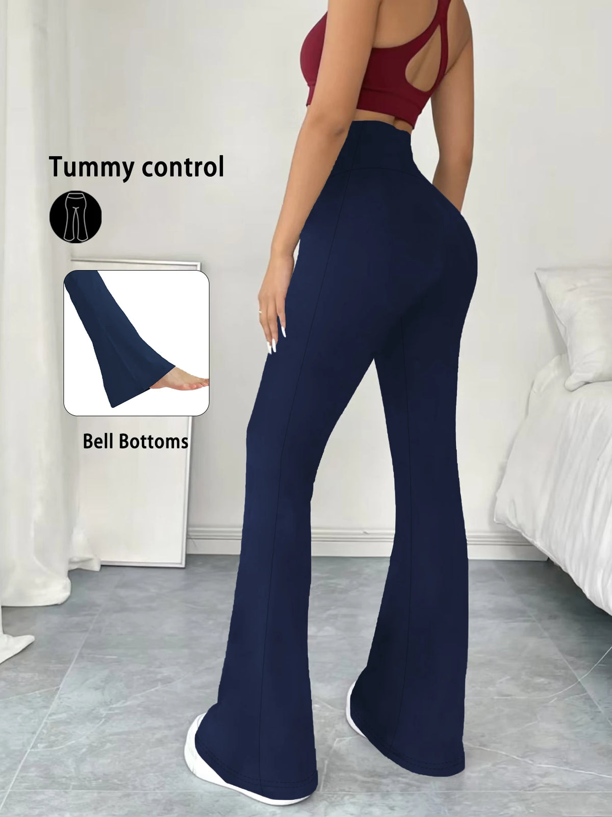 A model wearing navy blue high-waisted yoga leggings with flare details, demonstrating tummy control and bell bottoms.