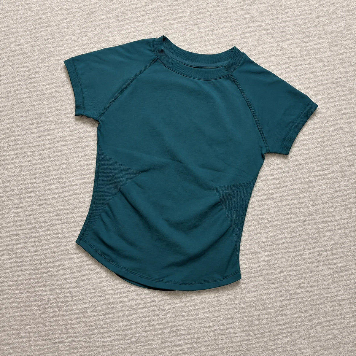 A teal seamless high-waist yoga set for women shown flat lay.