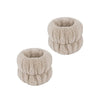 A pair of light beige microfiber spa headband and wristband set with a fluffy texture.