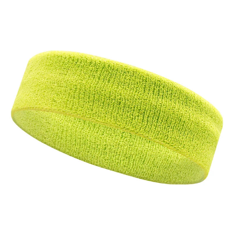 A bright lime green moisture-wicking athletic headband rolled into a cylinder.