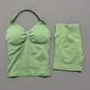 A lime green women's seamless fitness set consisting of a cropped top and matching leggings.