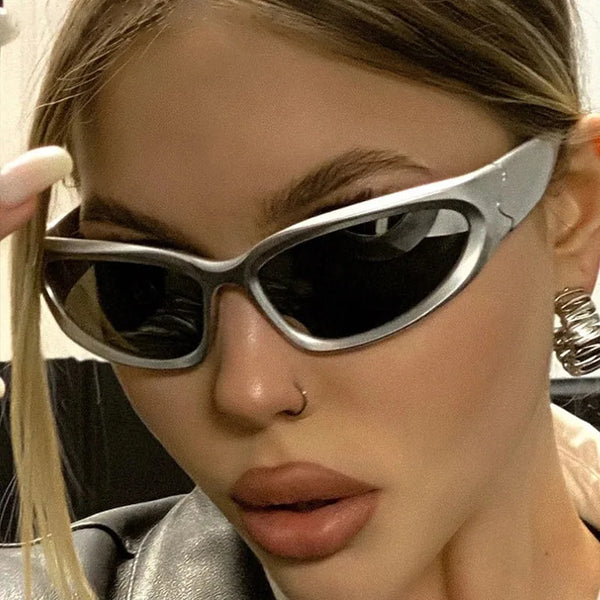 Close-up of a woman wearing silver vintage rectangle aviator sunglasses