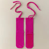 A pair of bright pink silicone anti-slip yoga socks with elastic drawstrings.