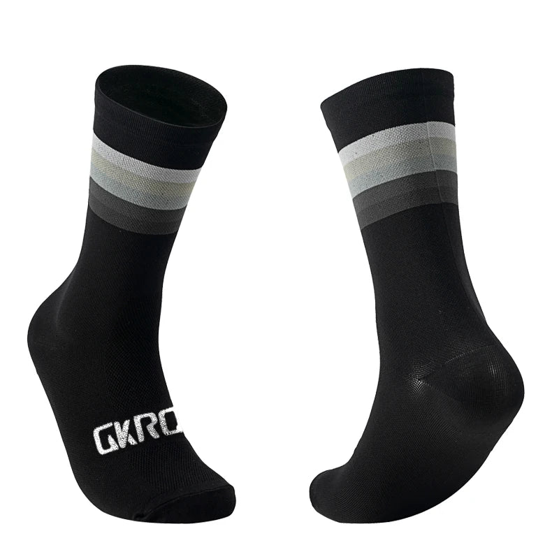 A pair of black cycling socks with a grey stripe detail, shown from the side.