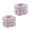 A pair of light purple microfiber spa headband and wristband set with a fluffy texture.
