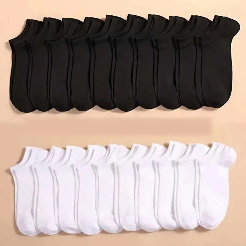 A set of black and white ankle socks for sports and casual wear displayed in a row.