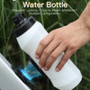 A hand is holding a white magnetic quick-release water bottle, demonstrating its easy attach and remove features.