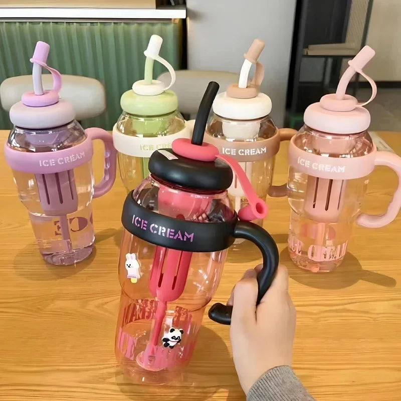 A hand is holding a pink plastic drinking cup filled with ice cream, surrounded by several similar cups.