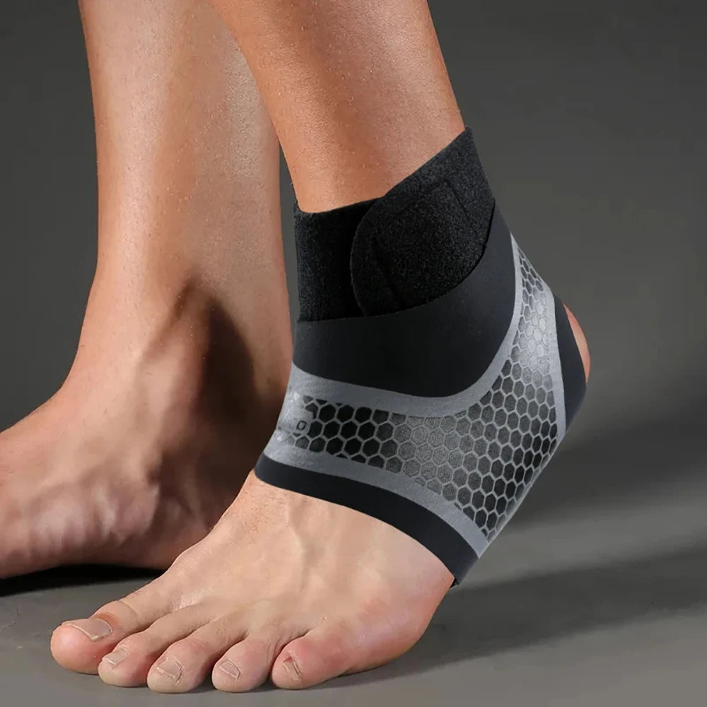 A close-up of a black and gray compression ankle brace worn on a person's foot.