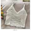 White off-shoulder camisole tank top for women displayed on a light surface.