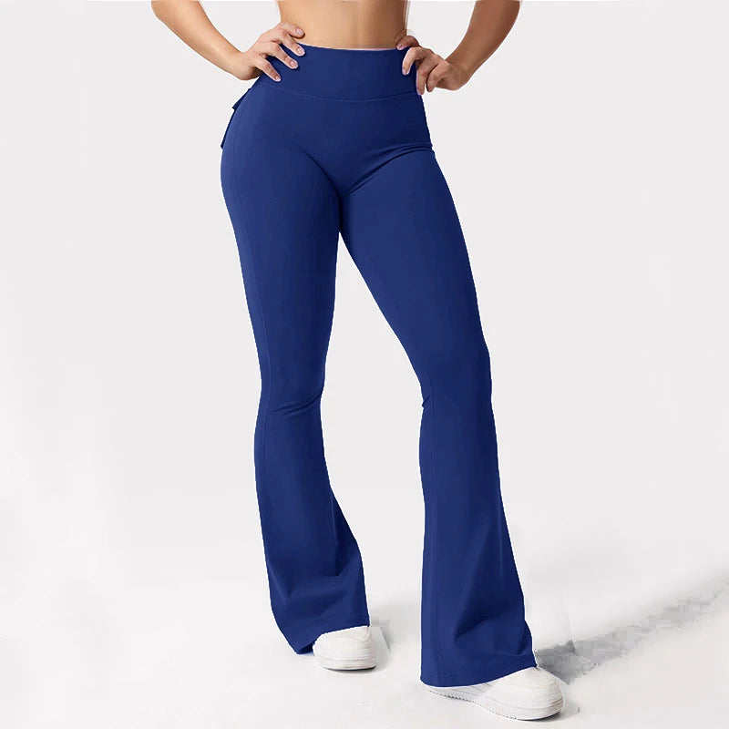 A woman wearing royal blue high stretch yoga leggings standing and posing.