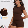 A model wearing a brown sports casual tracksuit top and shorts, highlighting dual side pockets.