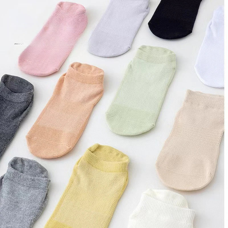 A collection of multi-pack women's yoga and fitness socks in various pastel colors including pink, lavender, green, beige, an