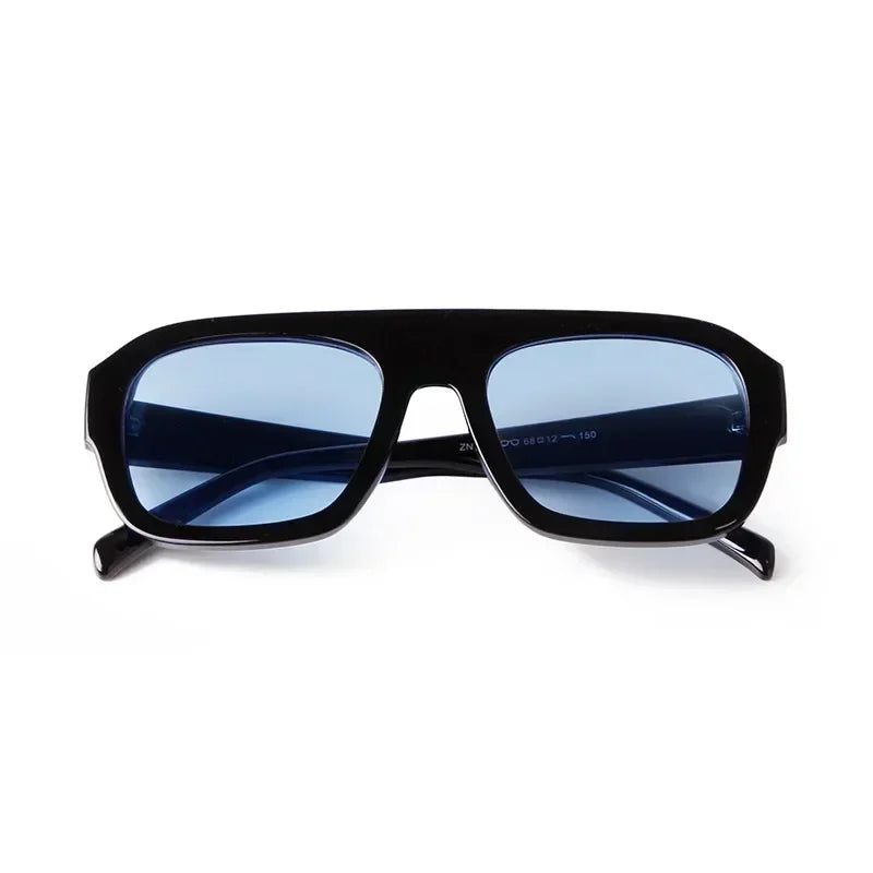 Vintage oversized square sunglasses with a dark blue lens and black frame.