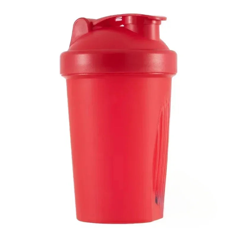 A red portable protein shaker bottle standing upright.