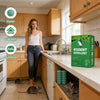 A box of rodent repellent balls is displayed on a kitchen counter next to a cabinet, with mice visible near the base of the c