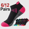 A pack of 12 pairs of black and pink knit sports socks displayed next to a red number tag.