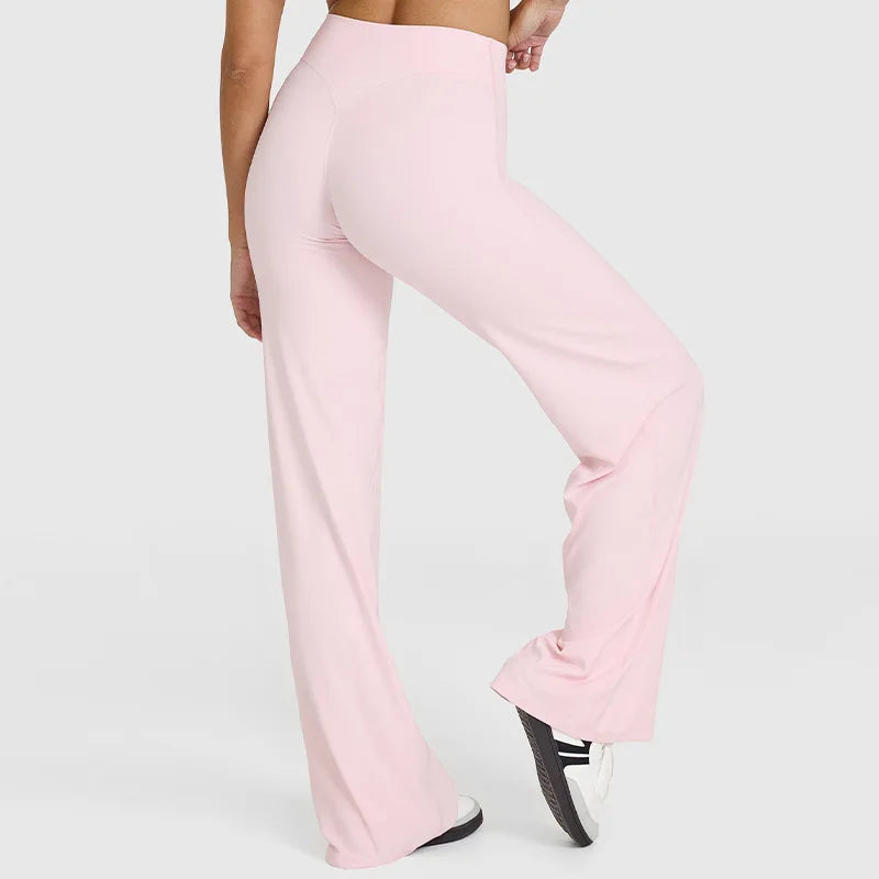 Light pink high-waist yoga pants shown on a model's legs.