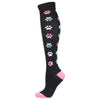 Black compression socks with colorful paw print patterns and pink accents