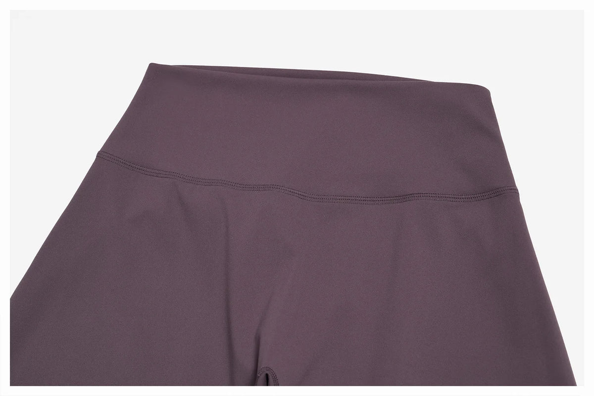 A close-up view of a solid purple women's high-waist flared yoga pant.