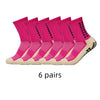 Sechs Paar leuchtend pinker Sporthochs mit rutschfester Performance in einer Reihe.