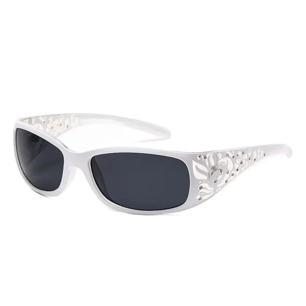 White sunglasses with a cat eye shape and silver rhinestone detailing