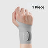 A single gray wrist compression brace is shown on a person's forearm.