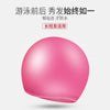 A pink silicone swimming cap shown in a close-up, round shape.