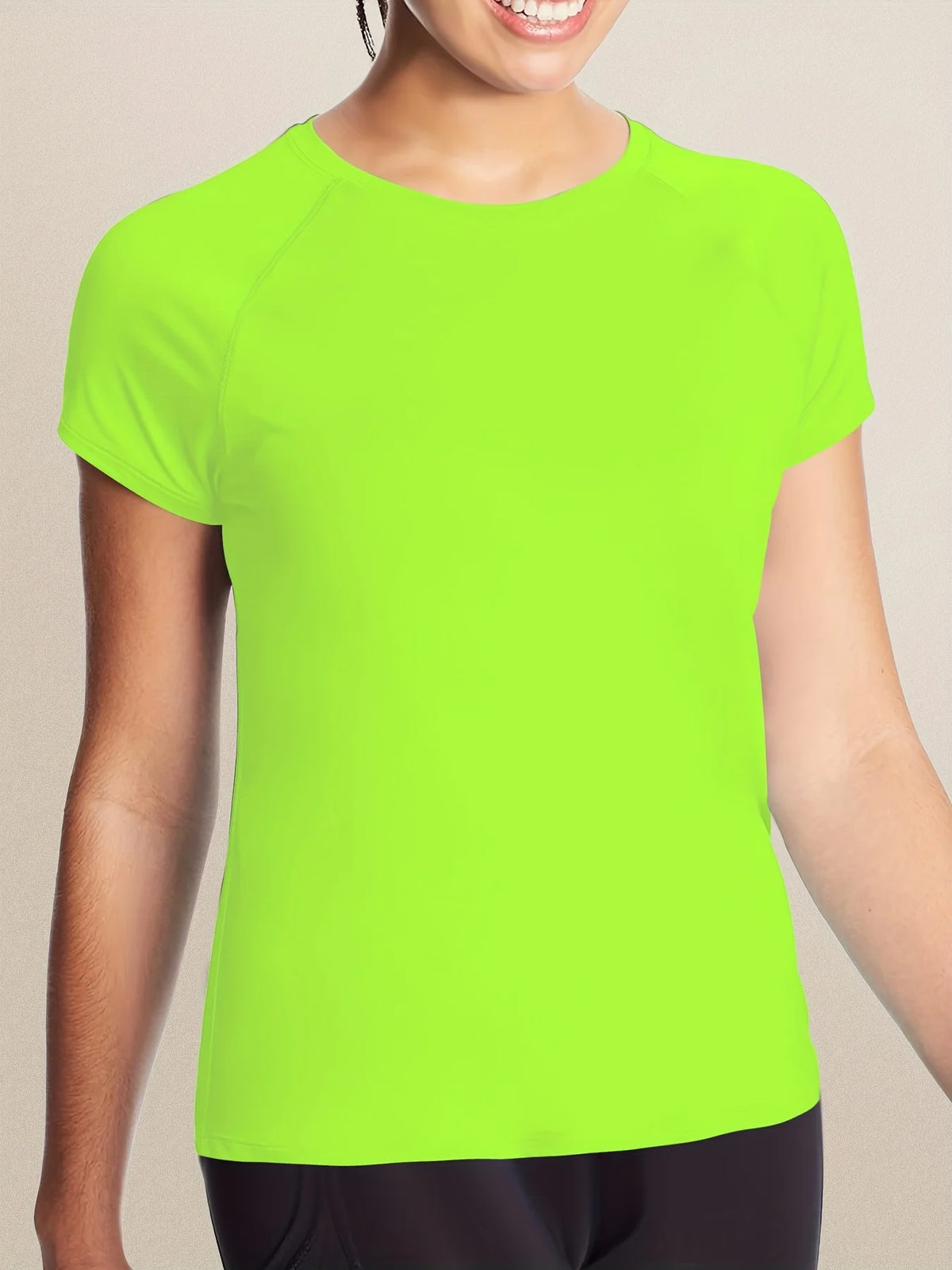 A bright lime green women's quick dry moisture-wicking gym t-shirt being worn by a model.