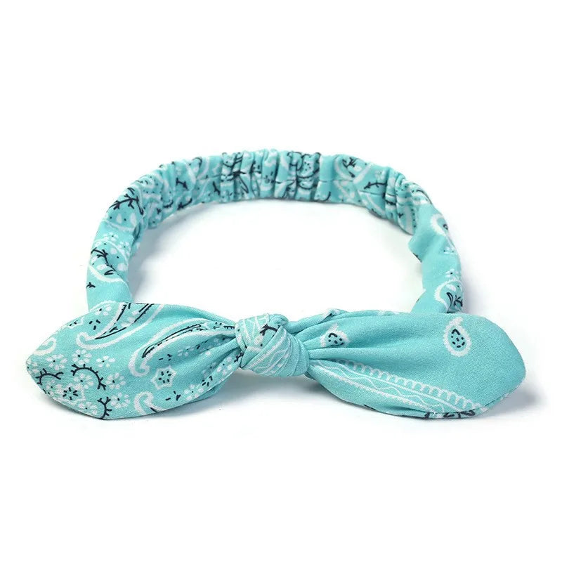 Light blue boho paisley elastic hair headband tied in a bow