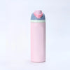 A pink insulated stainless steel thermos mug with a light blue lid and straw component.