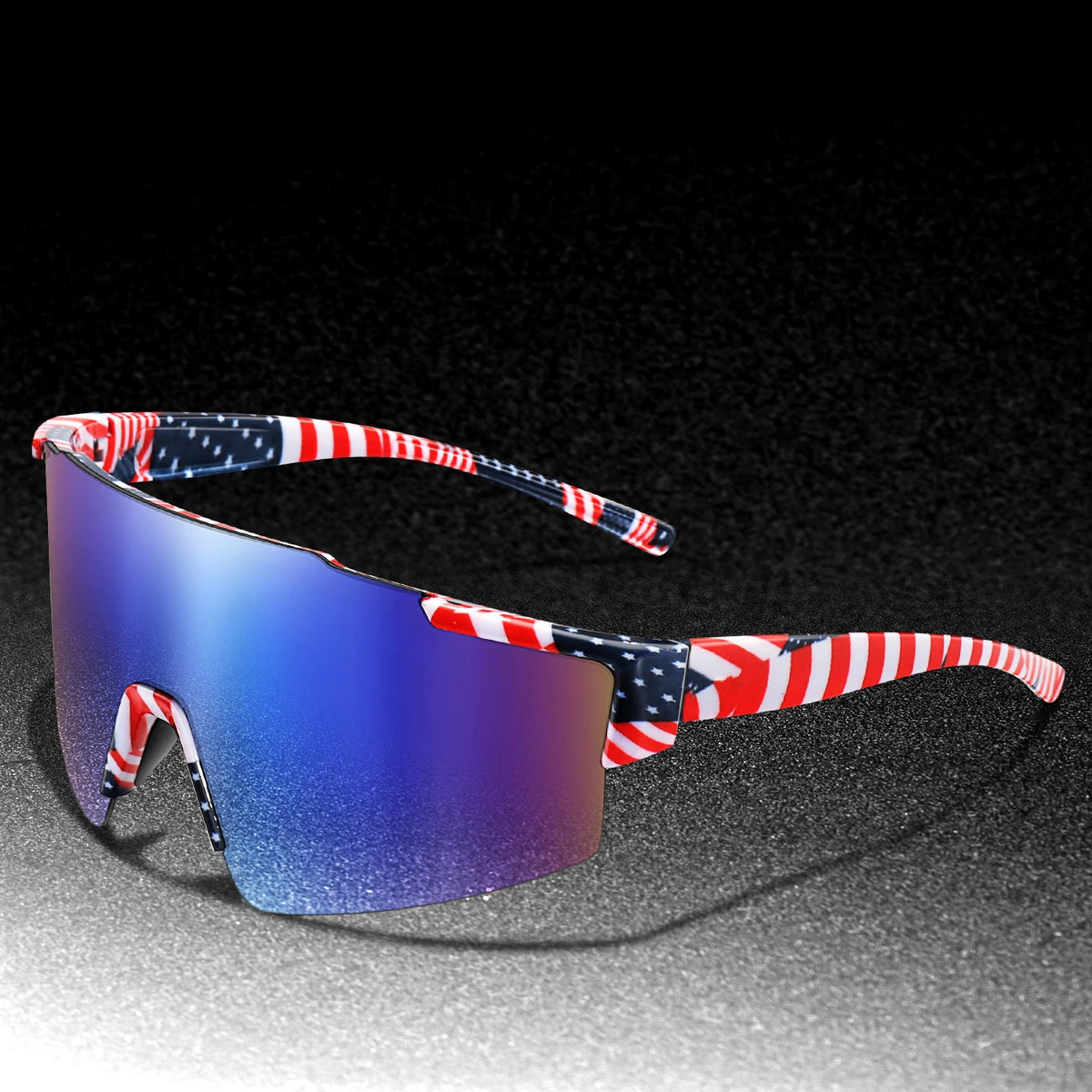 A pair of red, white, and blue patterned cycling sunglasses resting on a dark surface.
