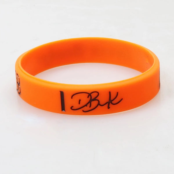 Orange silicone wristband for men with the initials DBK engraved on the surface