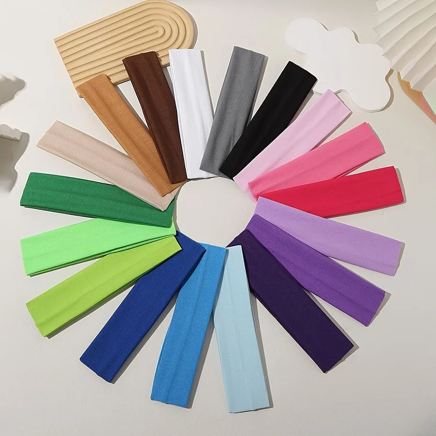 Eine Sammlung farbenfroher elastischer Stirnbänder in verschiedenen Farbtönen wie rosa, lila, grün und schwarz.