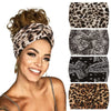 A woman models a leopard print yoga headband on her forehead, smiling.
