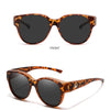 Front view of COL.12 round sunglasses with brown leopard print frames and dark lenses.