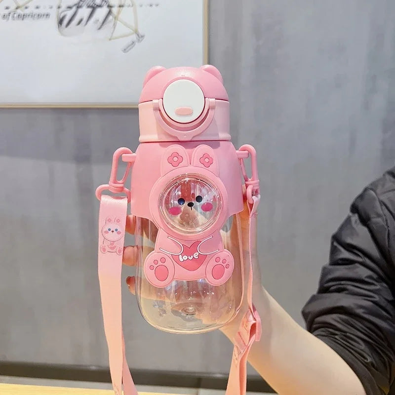 A pink leak-proof water bottle shaped like a cartoon animal with a cute face and paw prints.