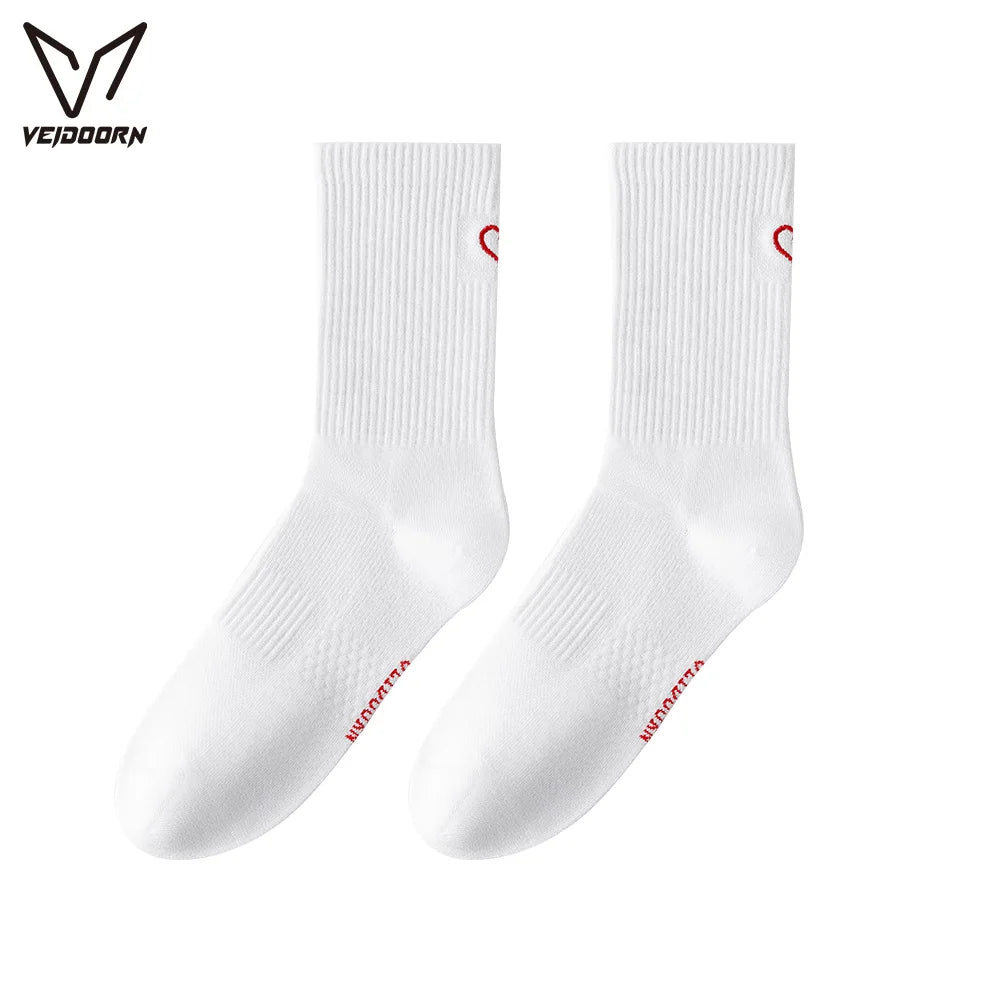 A pair of white crew socks with red trim for athletic activities