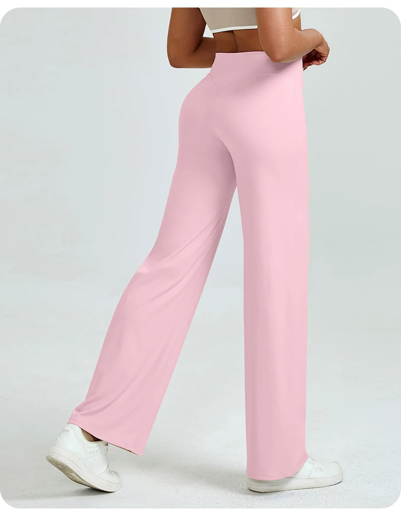A woman wearing light pink high waisted yoga pants and white sneakers.