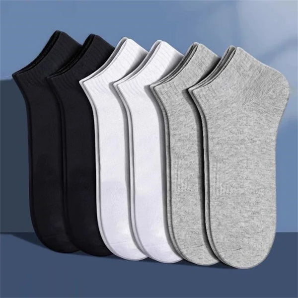 A set of men's breathable polyester cotton ankle socks in black, white, and gray stacked together.