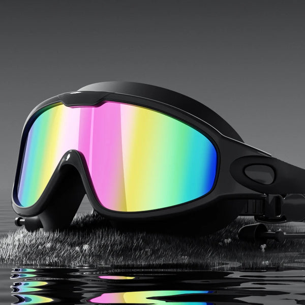 A pair of black swimming goggles with brightly colored lenses resting on a wet, reflective surface.