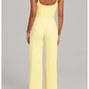 A woman models a yellow high-waist yoga and fitness tracksuit set.