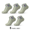 Five pairs of grey ankle socks with a navy blue logo detail