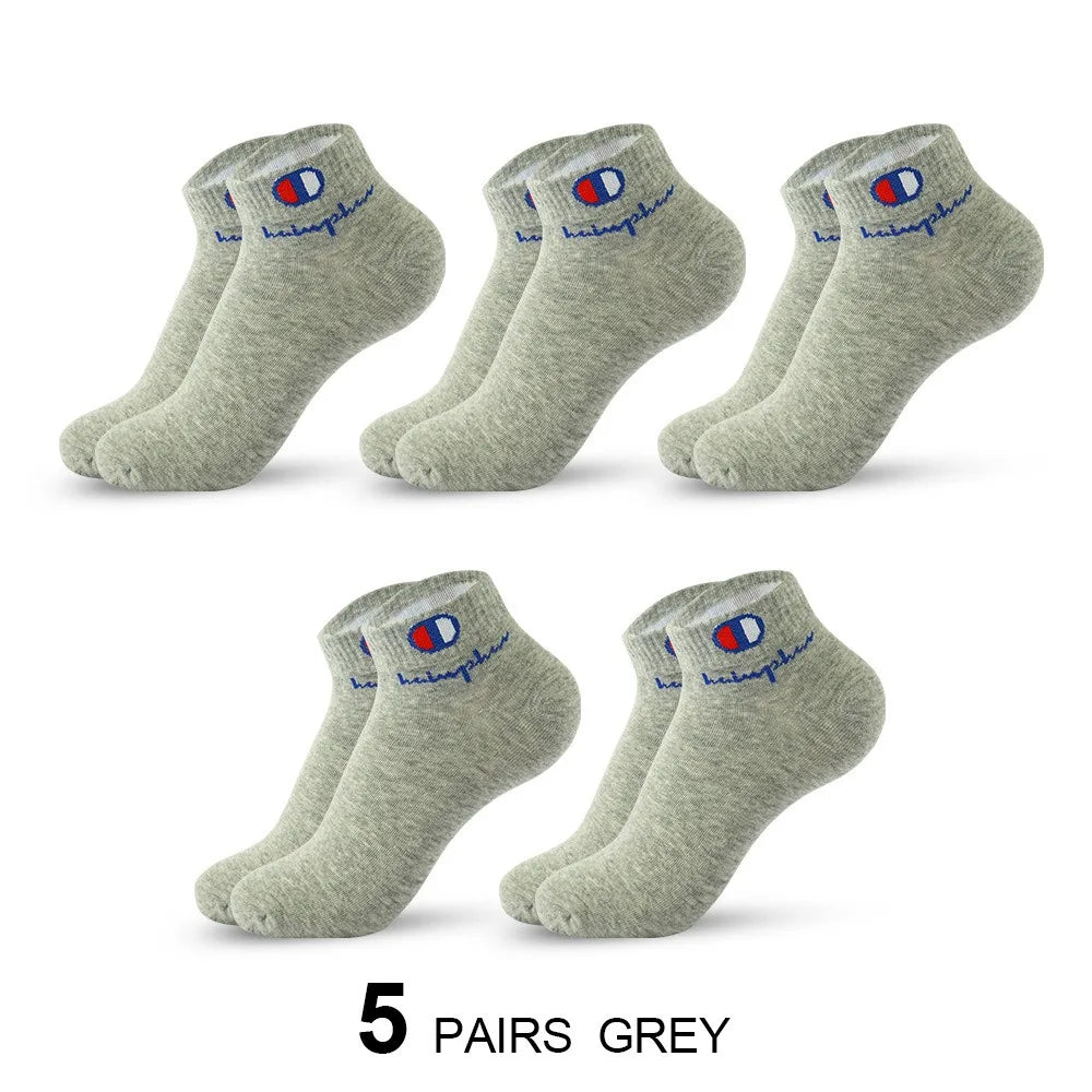 Five pairs of grey ankle socks with a navy blue logo detail