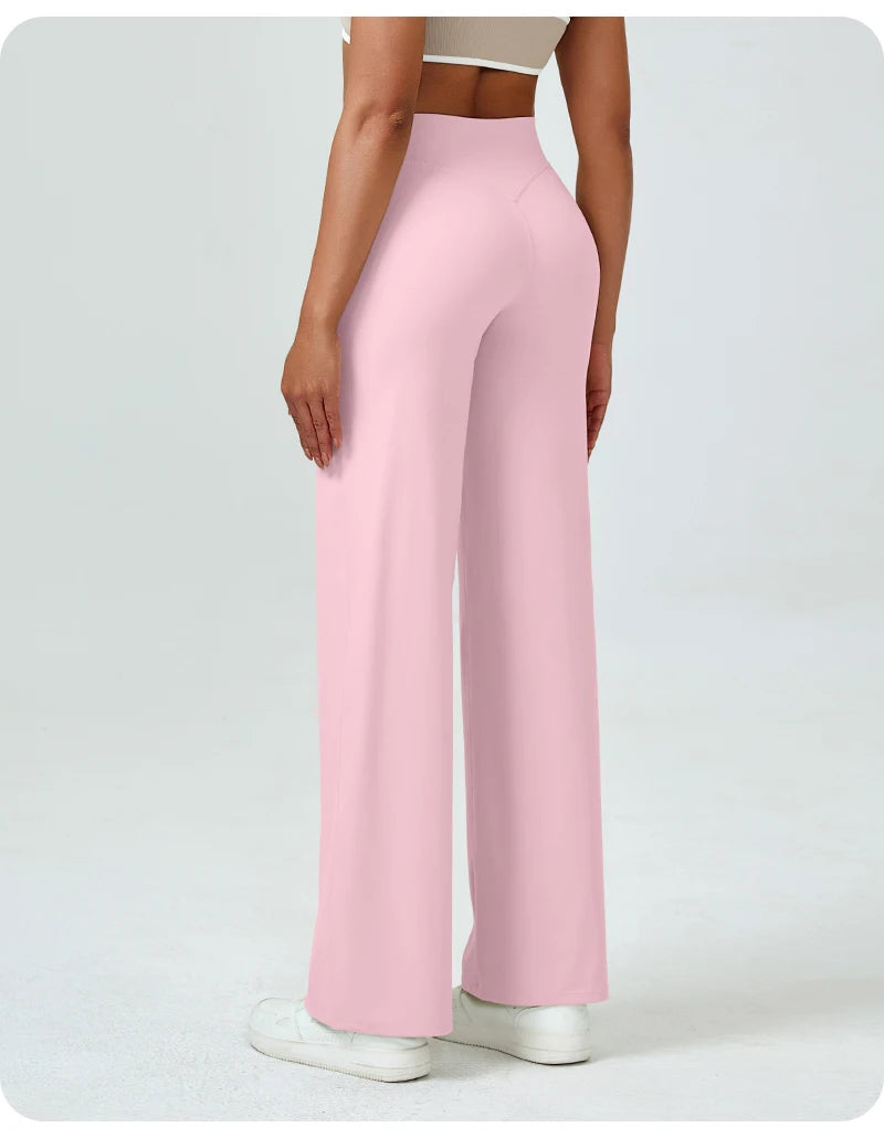 A woman is modeling high waisted pink yoga pants with a light top.