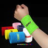 A collection of colorful durable sport wristbands shown on a wrist, including green, pink, purple, red, yellow, blue, and whi