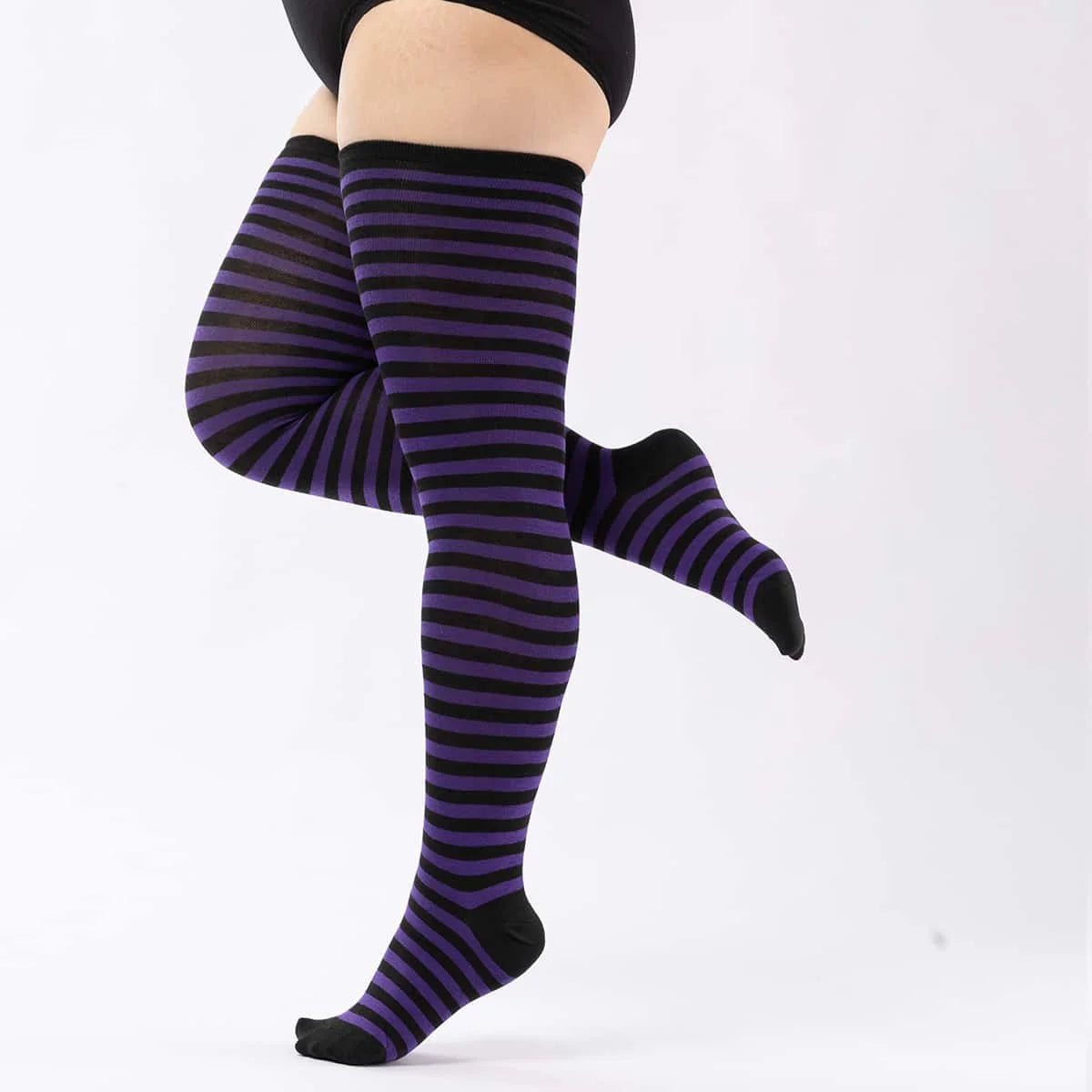 A pair of plus size striped thigh high leg warmers in purple and black.