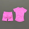 A bright pink seamless yoga set for women featuring a short sleeve top and workout leggings.