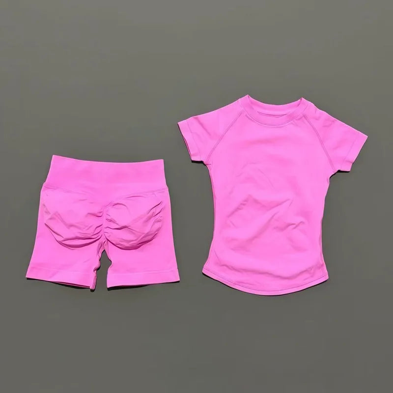 A bright pink seamless yoga set for women featuring a short sleeve top and workout leggings.